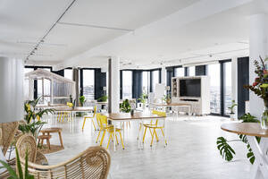 Empty chairs and table arranged at cafeteria in office - PESF02831