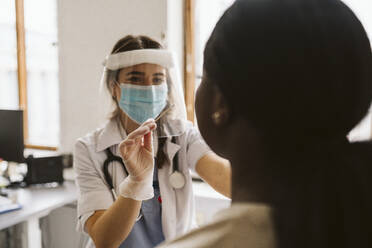 Female medical expert doing patient's medical test during COVID-19 - MASF23944