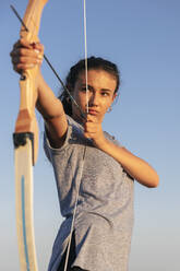 Archeress aiming with bow and arrow - JRVF00985