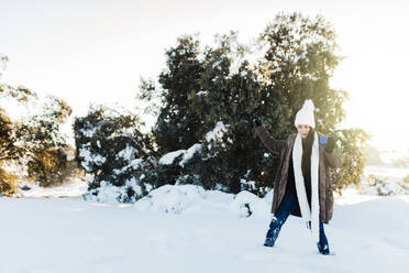 Happy woman enjoying weekend on snow - MRRF01248