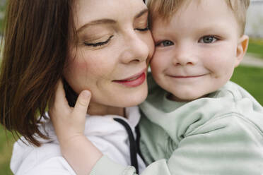 Cute son with mother in park - EYAF01624