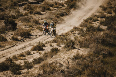 Bikers riding motorcycles at desert - DMGF00544
