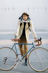 Hübscher Mann lehnt sich an ein Fahrrad - AGGF00125