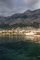 Croatia, Split-Dalmatia County, Makarska, Makarska Riviera harbor with Biokovo range in background - MAMF01862