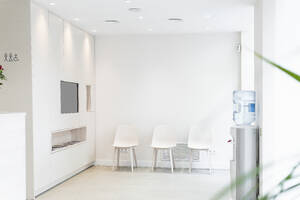 Empty chairs in waiting room of medical clinic - PNAF01940