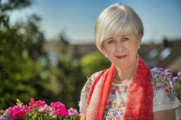 Senior woman wearing scarf on sunny day - FRF00934