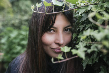 Beautiful woman looking through twigs - DSIF00436