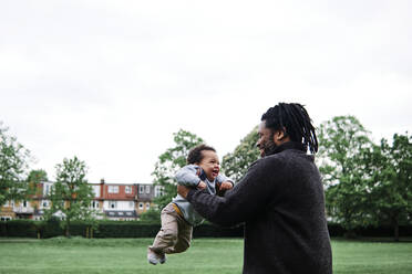 Playful father with son at park - ASGF00531