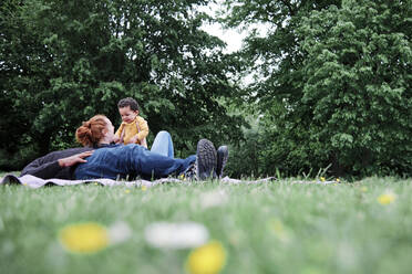 Parents enjoying leisure time with son at park - ASGF00543