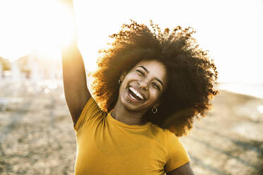 Happy woman enjoying at beach during sunset - DAF00069