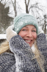 Happy mature woman wearing knit during winter - FVDF00246