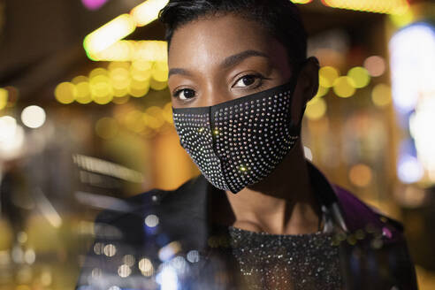 Portrait confident young man in studded face mask - CAIF30809