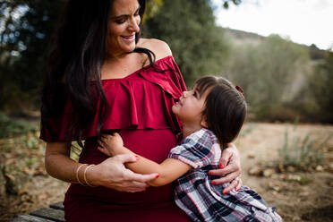 Expectant Mother Holding Daughter in San Diego - CAVF94118