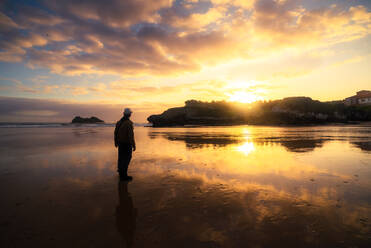 Unrecognizable man enjoying a sunset by the sea on a summer day - ADSF24702