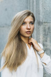 Young beautiful woman with blond hair looking away - DAMF00834