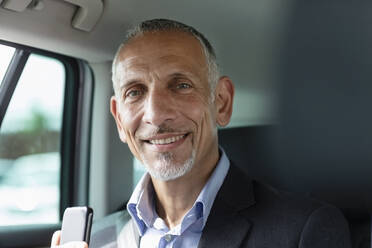Smiling male professional sitting in car - EIF01366