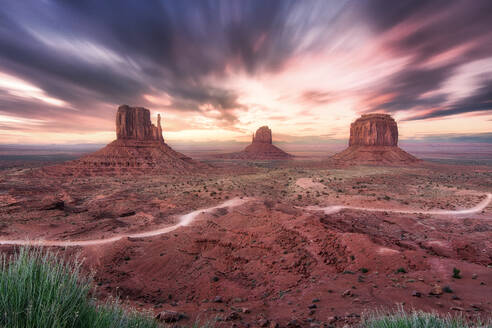 Spectacular scenery of tall rocky formations located in Monument Valley in America under colorful sky at sunset - ADSF24924
