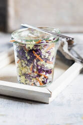 Salad in glass jar and chopsticks on tray - SBDF04489