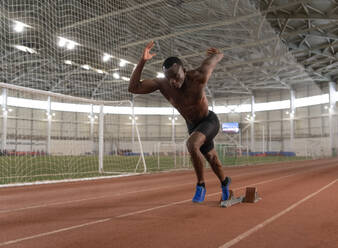 African American sportsman running during training - CAVF94288