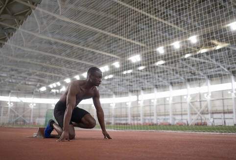 African American athlete preparing to run near net - CAVF94291