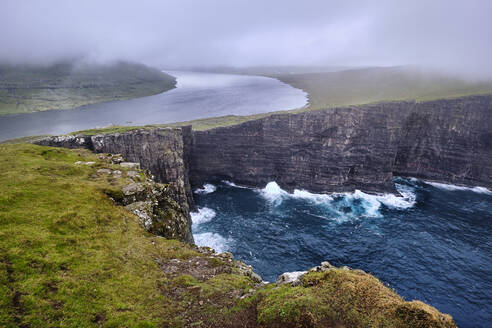 Cliffs of Traelanipa with the lake above the ocean, Faroe Islands, Denmark, Europe - RHPLF19877