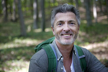 Smiling handsome male hiker with gray hair and stubble - FMKF07202