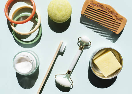 Studio shot of wooden comb, bamboo toothbrush, colorful bracelets, organic soap, shampoo and other eco-friendly self-care products - GEMF04879