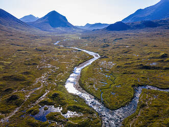 UK, Scotland, Aerial view of river winding across Black Cuillin range moor - RUNF04560