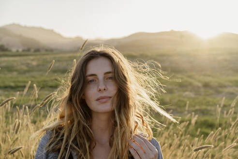 Young woman in agricultural field during sunset - AFVF09030