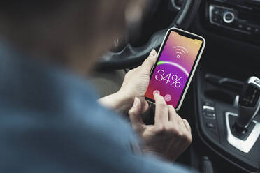 Woman connecting mobile phone with wifi in car - UUF23726
