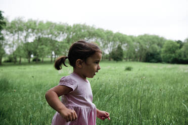 Girl running on grass in park - ASGF00726