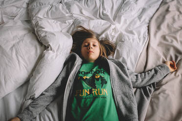 Bird's Eye View of Boy Laying on Fluffy Bed - CAVF94342