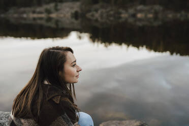 Young female explorer contemplating by lake - MASF24539