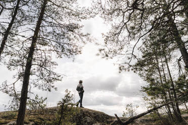 Mature woman hiking on mountain against sky - MASF24618