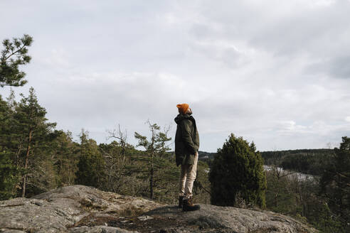 Älterer Mann mit Hand in der Tasche auf einem Berg stehend gegen den Himmel - MASF24622