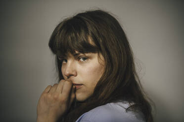 Portrait of young woman against white background - MASF24697