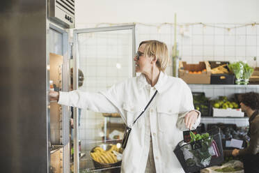 Blonde reife Frau kauft Lebensmittel im Laden - MASF25070