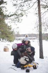 Fröhliche Mädchen spielen in den Ferien mit ihrem Vater im Schnee - MASF25099