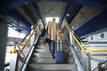 UK, London, Man with luggage walking up steps - ISF24661