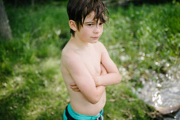 Canada, Ontario, Shirtless boy standing wet after swimming outdoors - ISF24672