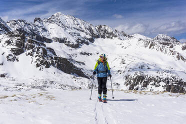 Junge Frau beim Skitourengehen im Hochgebirge von Colorado - CAVF94595