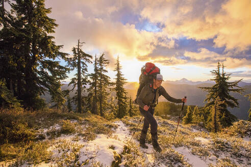 Backpacker enjoy the mountain view during sunet. - CAVF94607