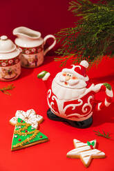 Studio shot of Christmas cookies and Santa Claus shaped teapot - FLMF00565