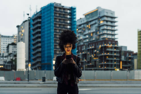 Woman using mobile phone while standing in city - MEUF03384