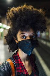 Woman with face mask at subway station during COVID-19 - MEUF03392