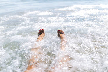 Young woman enjoying swimming in sea on sunny day - EGHF00079