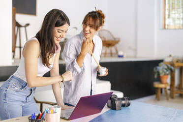 Happy female creative professionals discussing at studio - IFRF00899