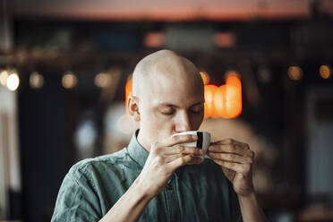 Male cafe owner drinking coffee - GUSF06085