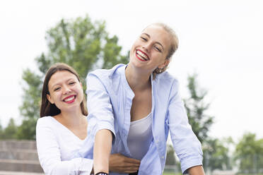 Cheerful female friends enjoying together - SGF02839