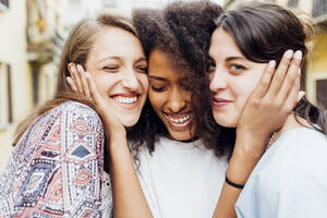 Smiling woman embracing friends - MEUF03451